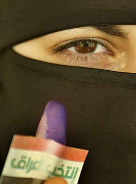 Iraqi woman with purple finger and tear in her eye
